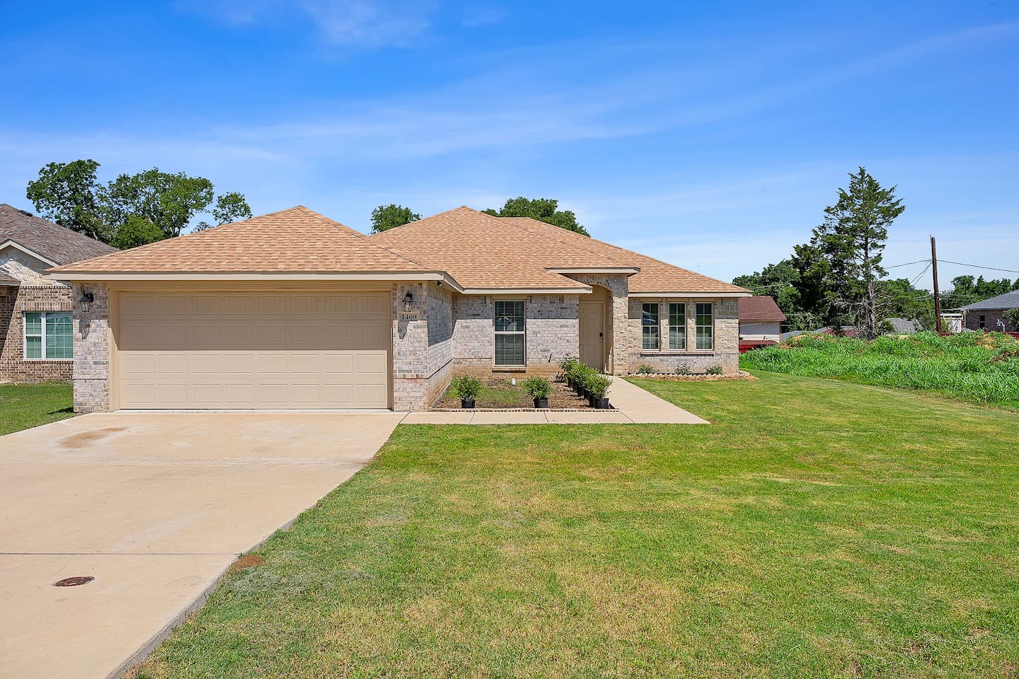 Step into a beautiful house with a large front lawn and ample parking space.