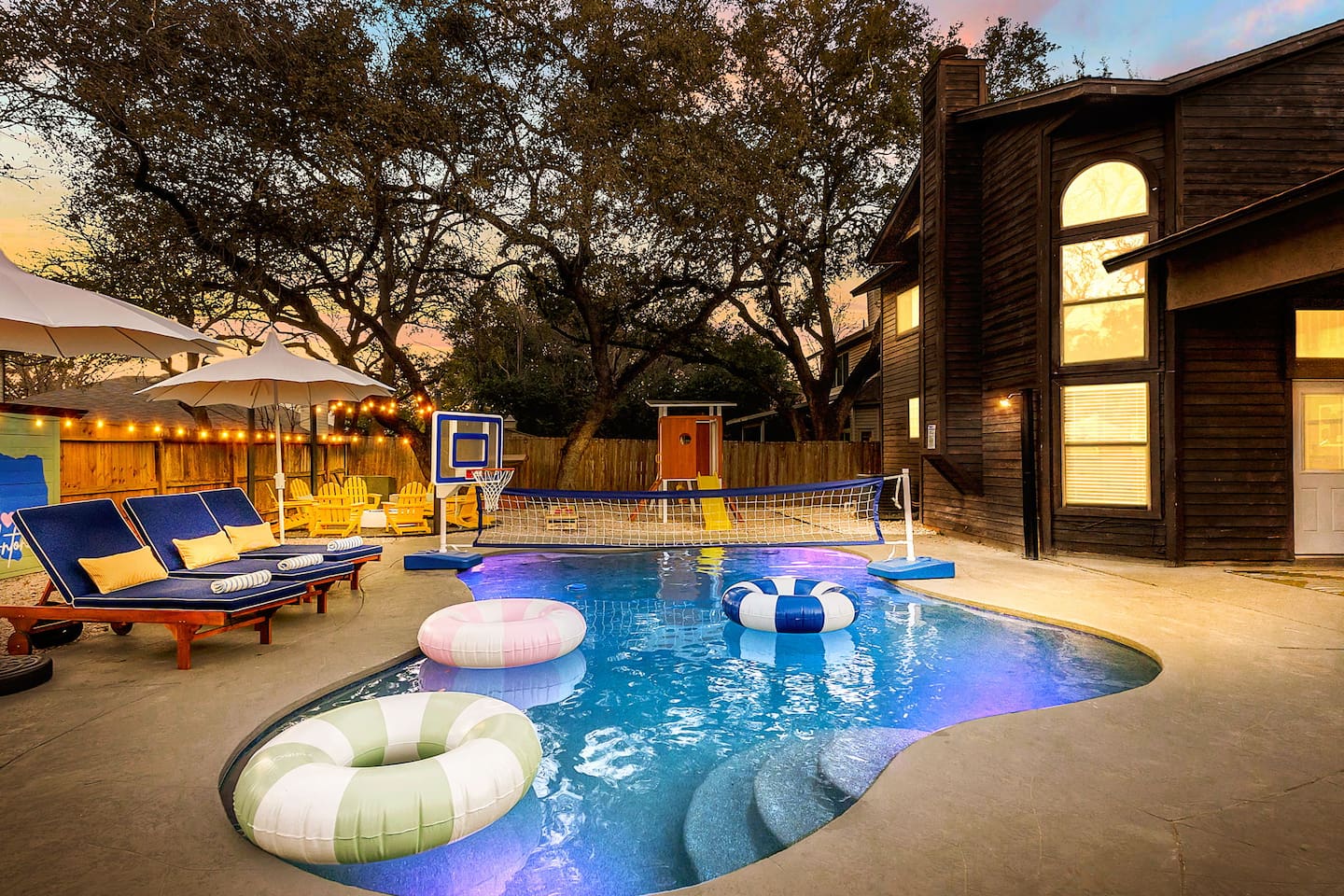 Sunset swim vibes   
Unwind poolside under string lights, take a dip, shoot hoops, or spike it over the net—your ultimate backyard escape awaits!