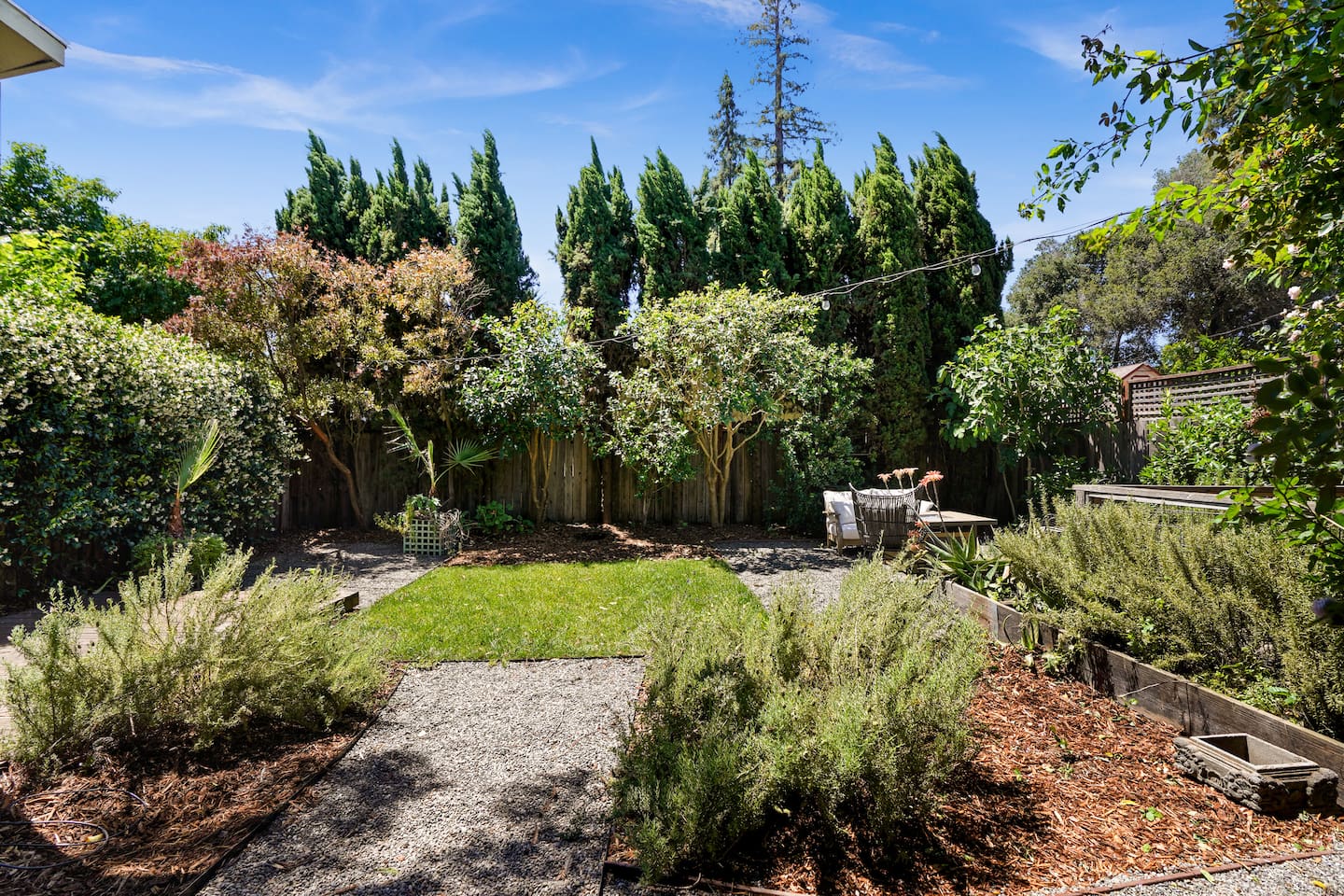 Private backyard retreat featuring a hot tub, fire pit, and multiple outdoor seating areas perfect for relaxing nights.