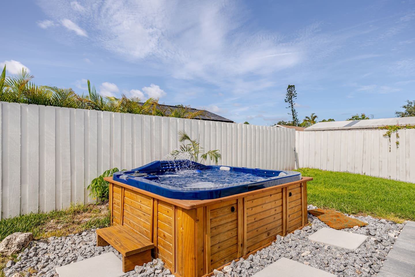 Private backyard with hot tub with jets and fountains
