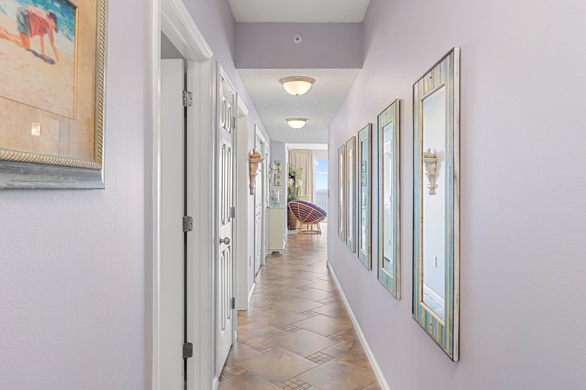 Hallway leading through the condo w/ crisp walls & an open, airy feel.