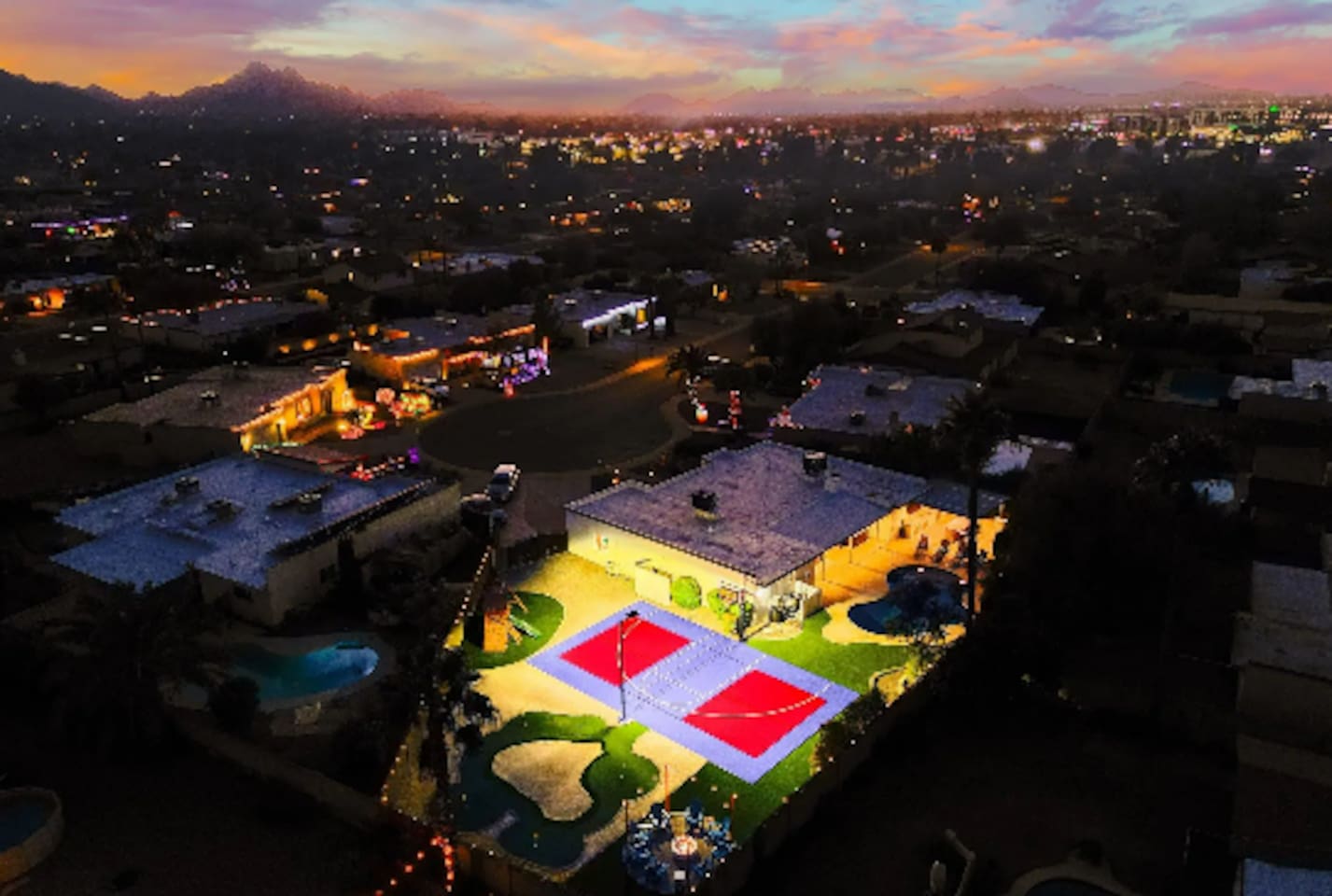 Golden hour over the property, court lights just coming on for the evening ahead.