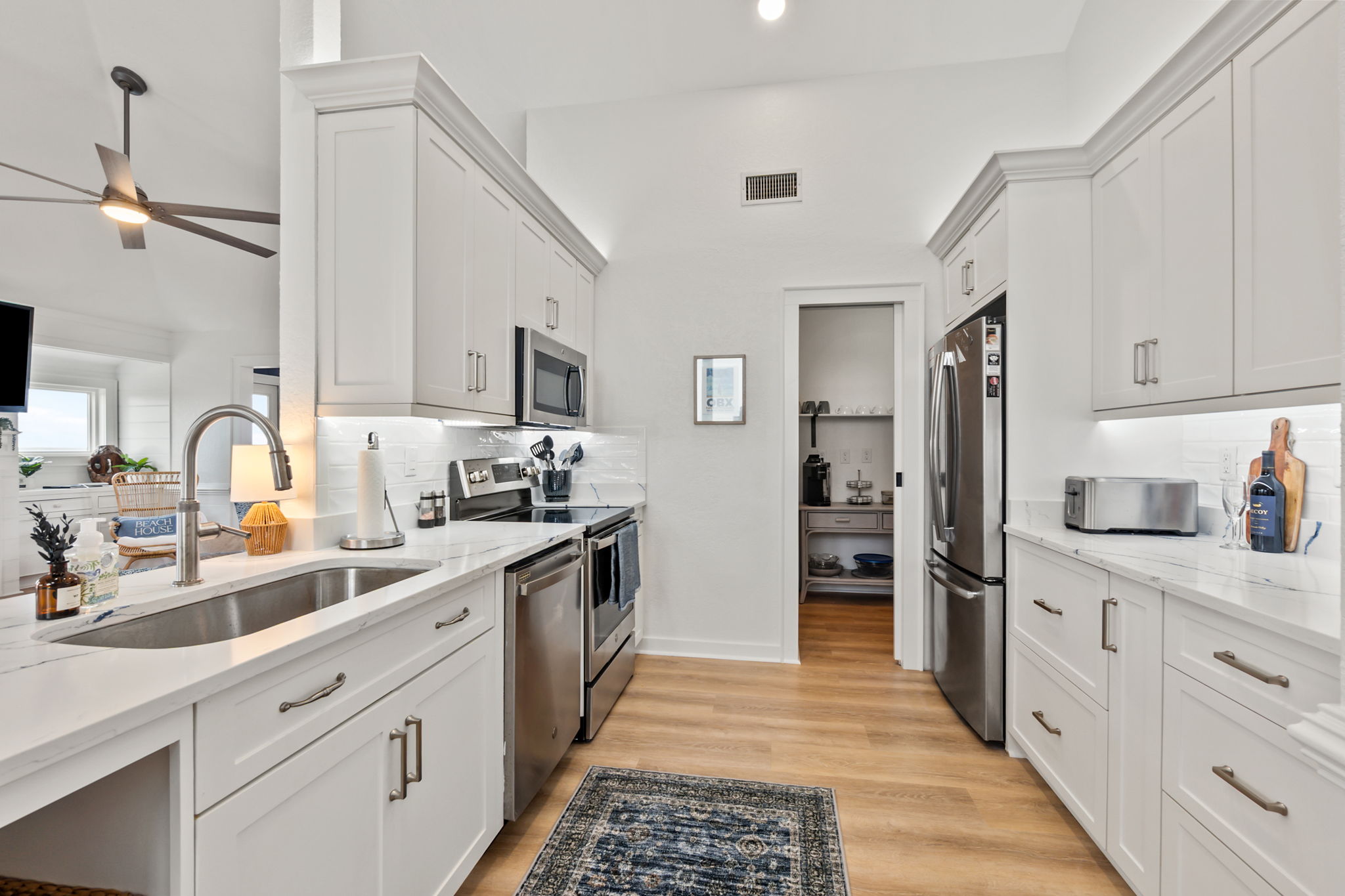 Spacious kitchen with modern appliances, plenty of counter space, and a clean, coastal feel.