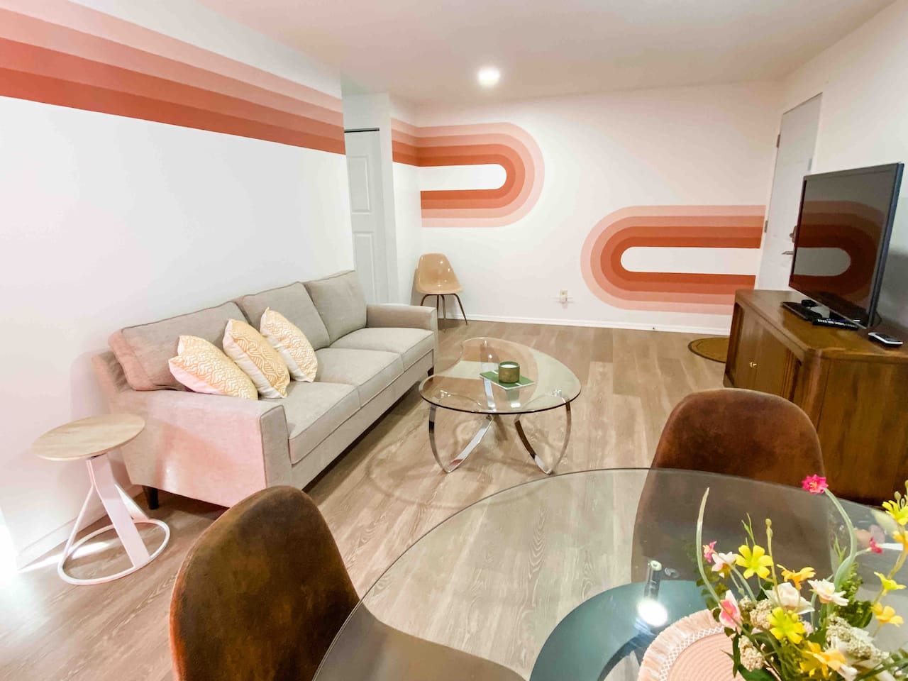 Living room with hand painted rainbow mural