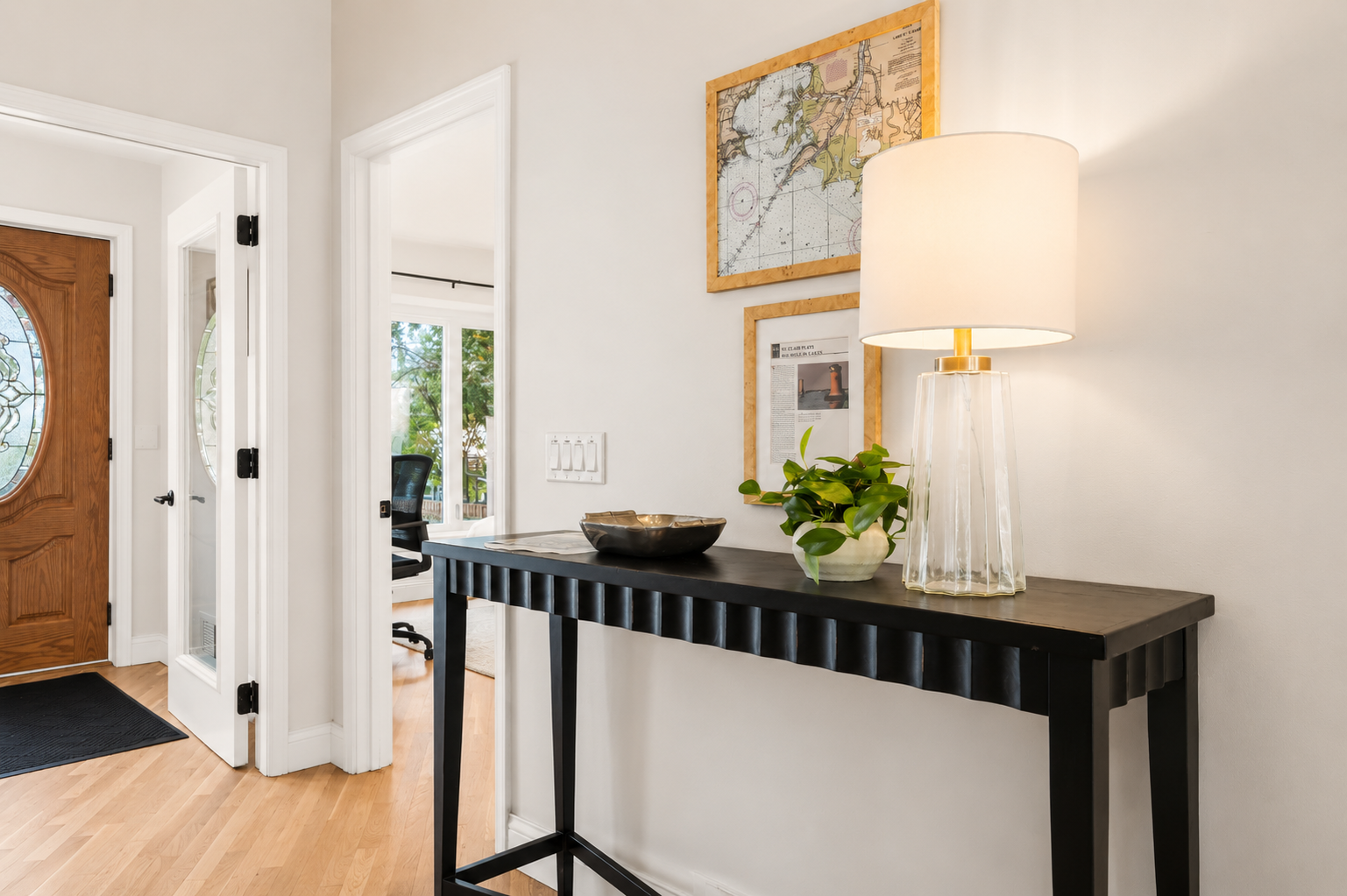 Bright entry console table with modern décor and warm lighting, creating a clean and welcoming first impression.