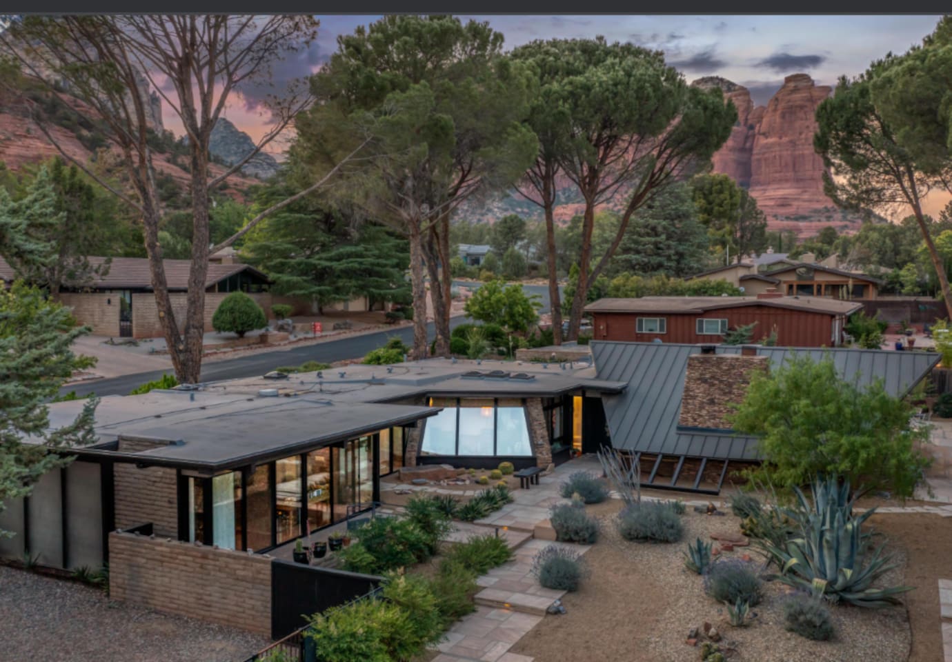 Stunning aerial view of this iconic mid-century retreat, surrounded by mature trees and dramatic red rock formations — a truly unforgettable setting where modern design meets Sedona’s natural beauty.