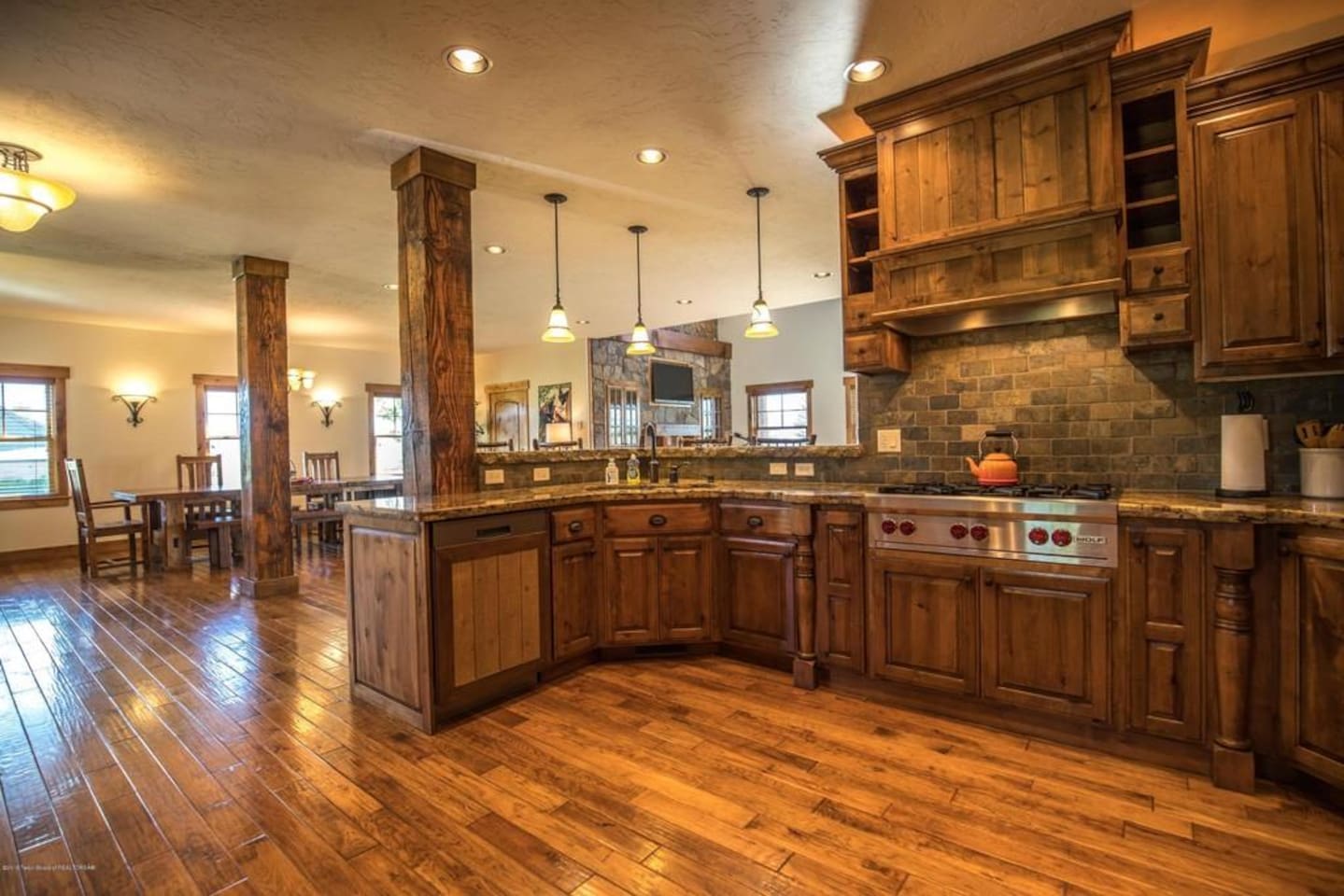 Open kitchen with updated appliances (e.g., Wolf range, Sub-Zero refrigerator)