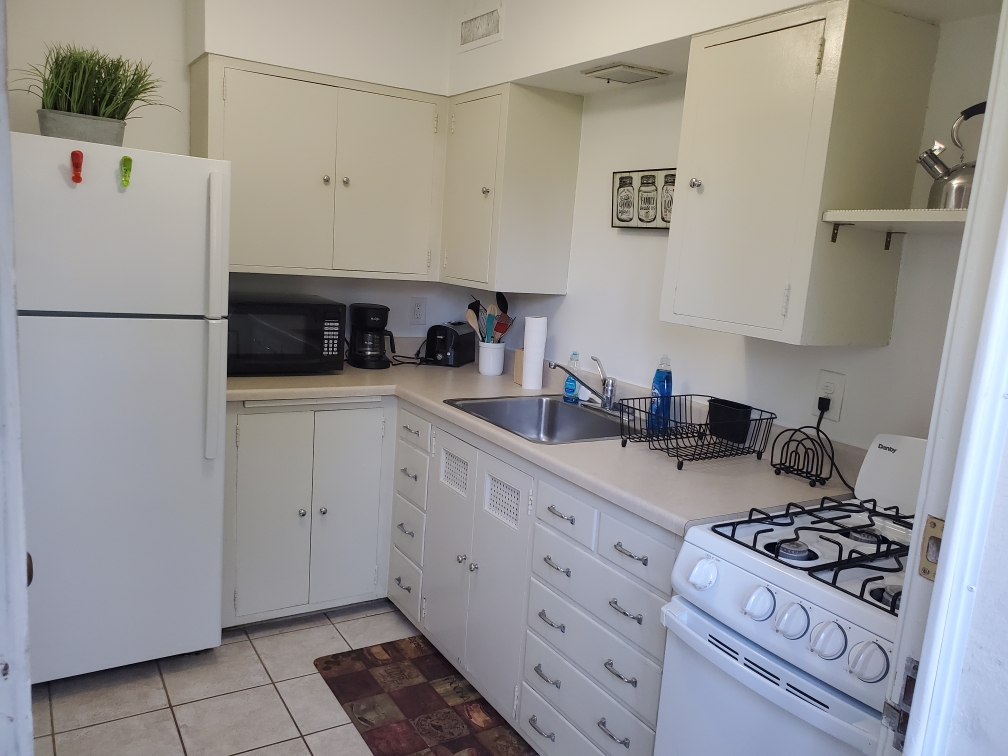 Kitchen w/essentials, microwave, stove, oven, refrigerator, freezer, coffee machine