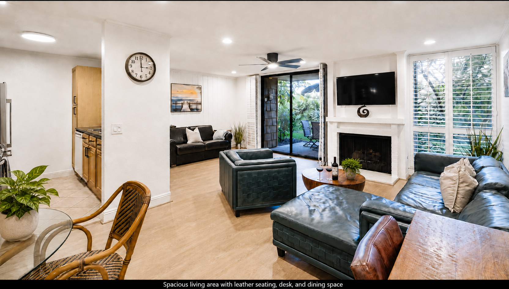 Spacious living area with leather seating, desk, and dining space