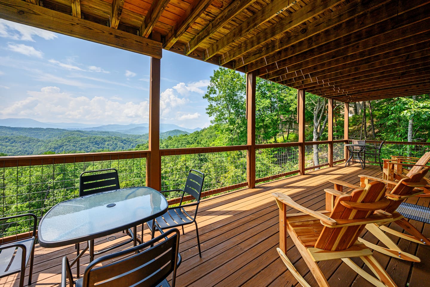 Lower deck views with two tables and 4 Adirondack rockers. 