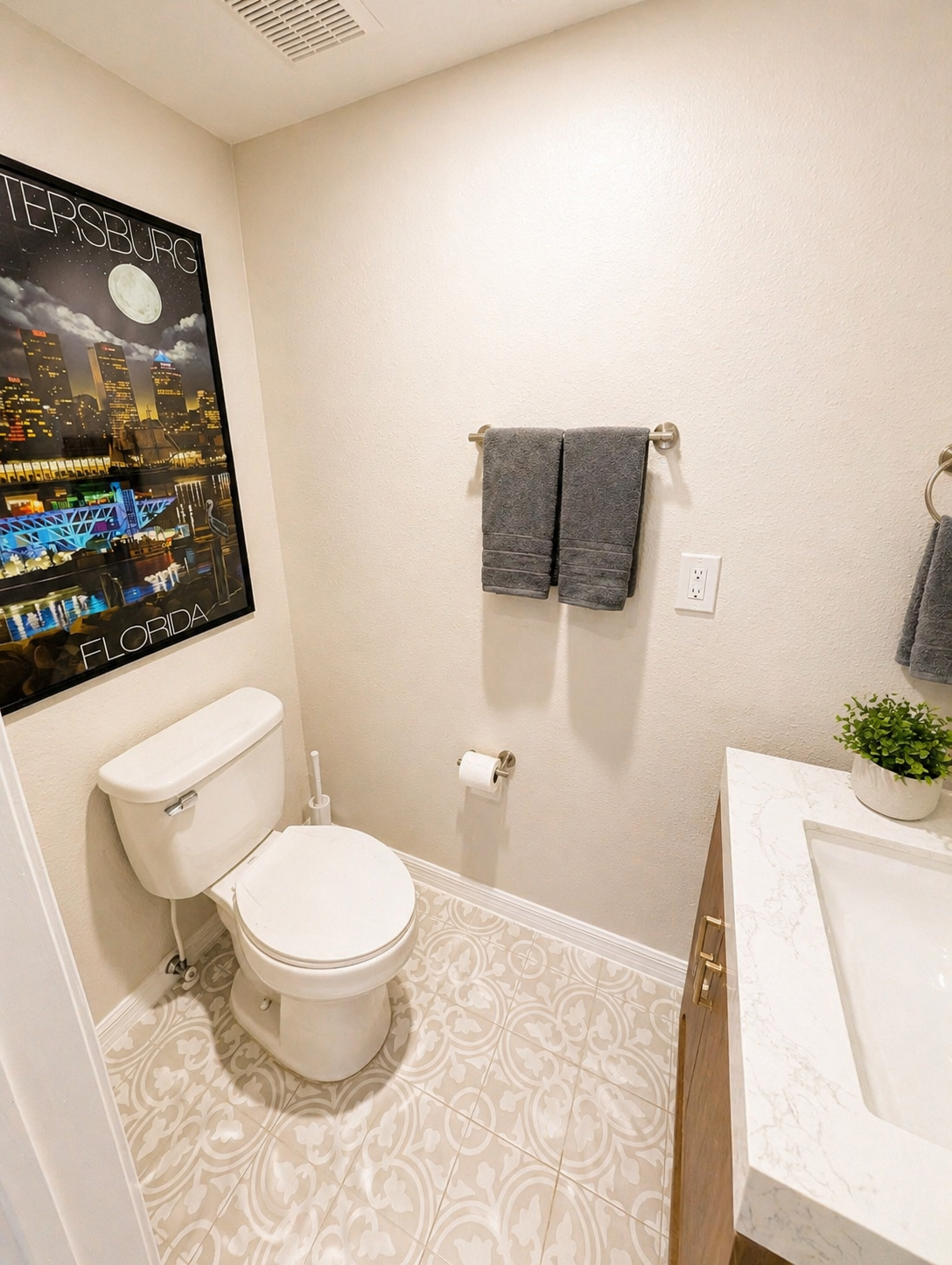 Clean and convenient half bath with a modern vanity, updated fixtures, and stylish tile flooring—perfect for guests and quick refreshes during your stay.