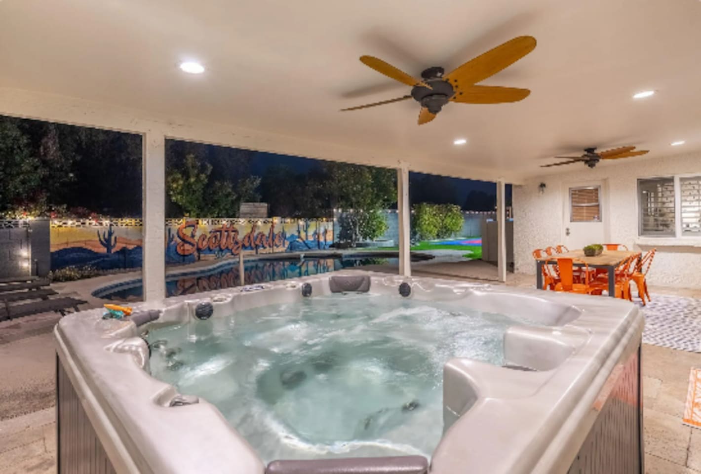 A private hot tub tucked under the patio, poolside views included, made for winding down after a long day in the sun.