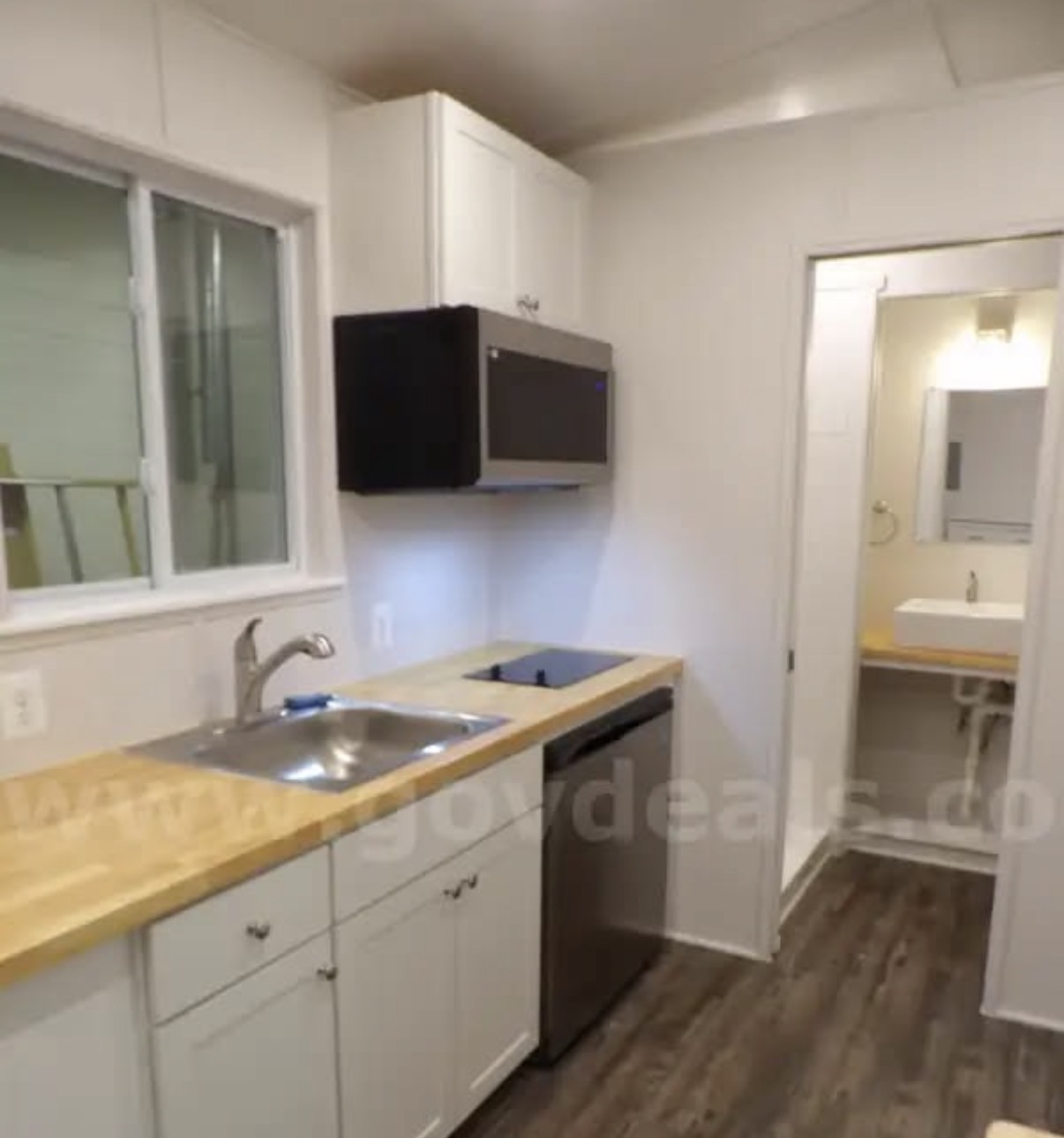 Kitchen with fridge/freezer combo, microwave and cooktop
