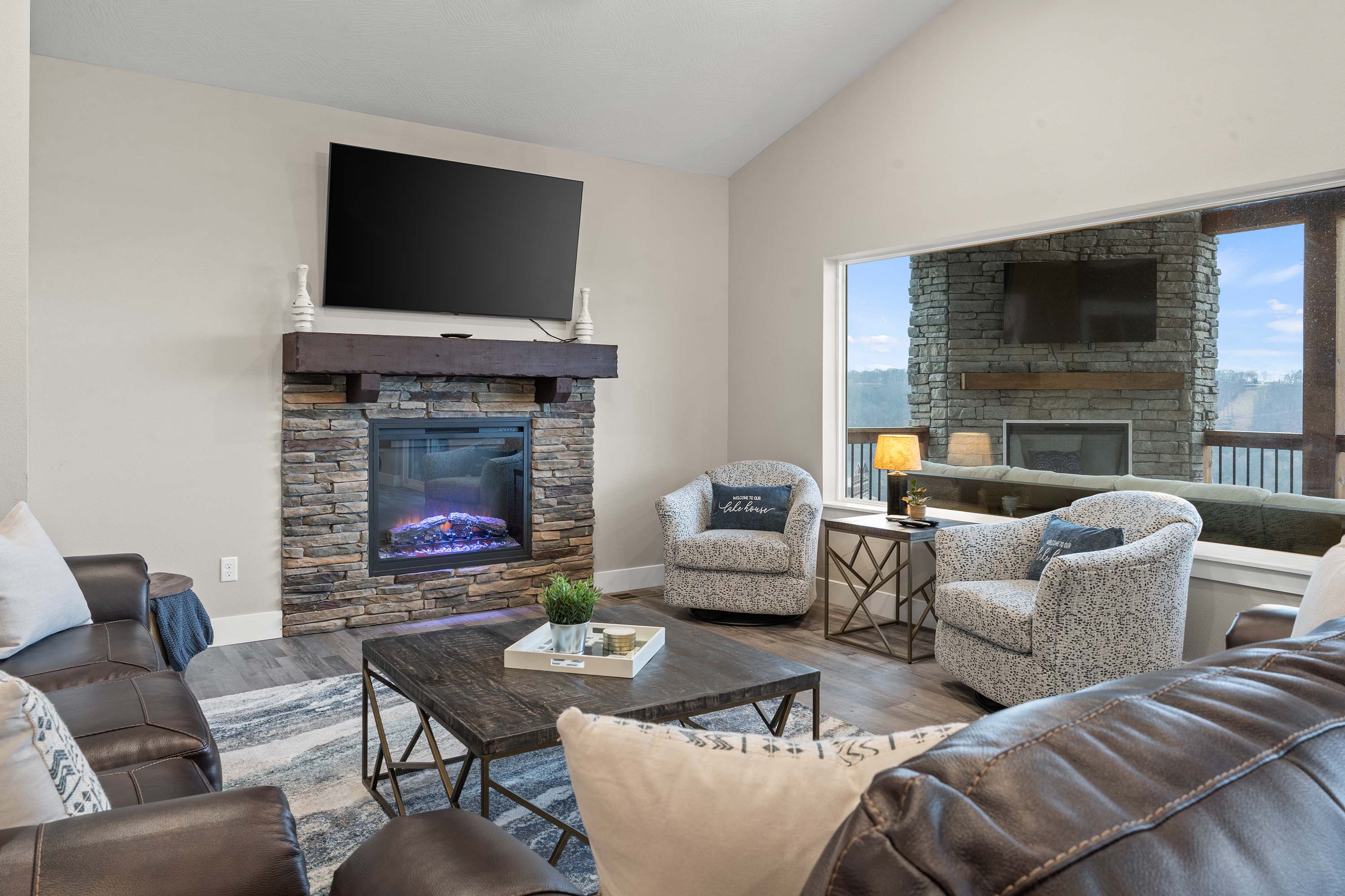 Main Level Living Room with fireplace and large TV.