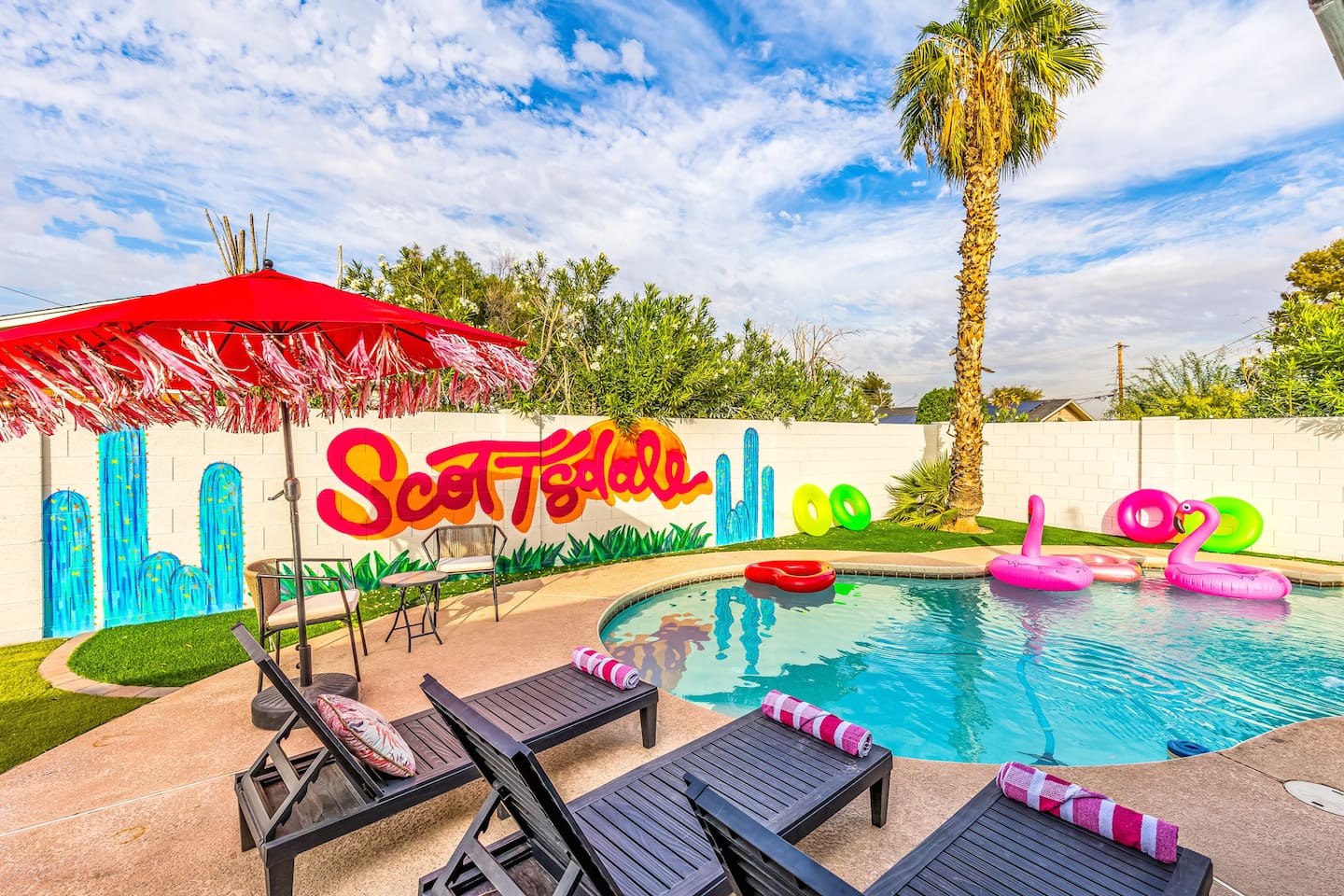 From bright umbrellas to palm trees and playful floaties, this backyard was made for unforgettable group hangouts.

