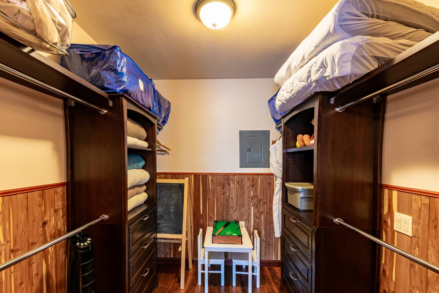 Walk in closet in master bedroom with extra blankets and pillows 