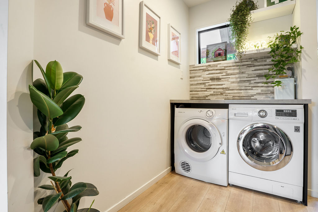 The laundry includes a washer, dryer and bench space, making Fernhill Mountain Escape well set up for longer stays or mountain days.