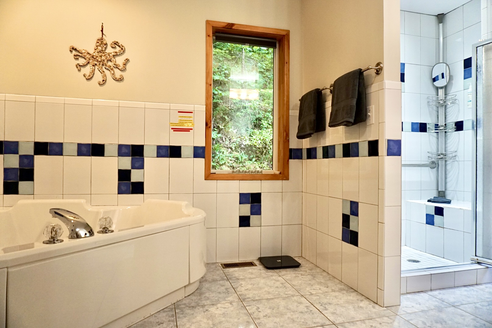 Indulge in a relaxing soak and scenic views in this elegant bathroom paradise!