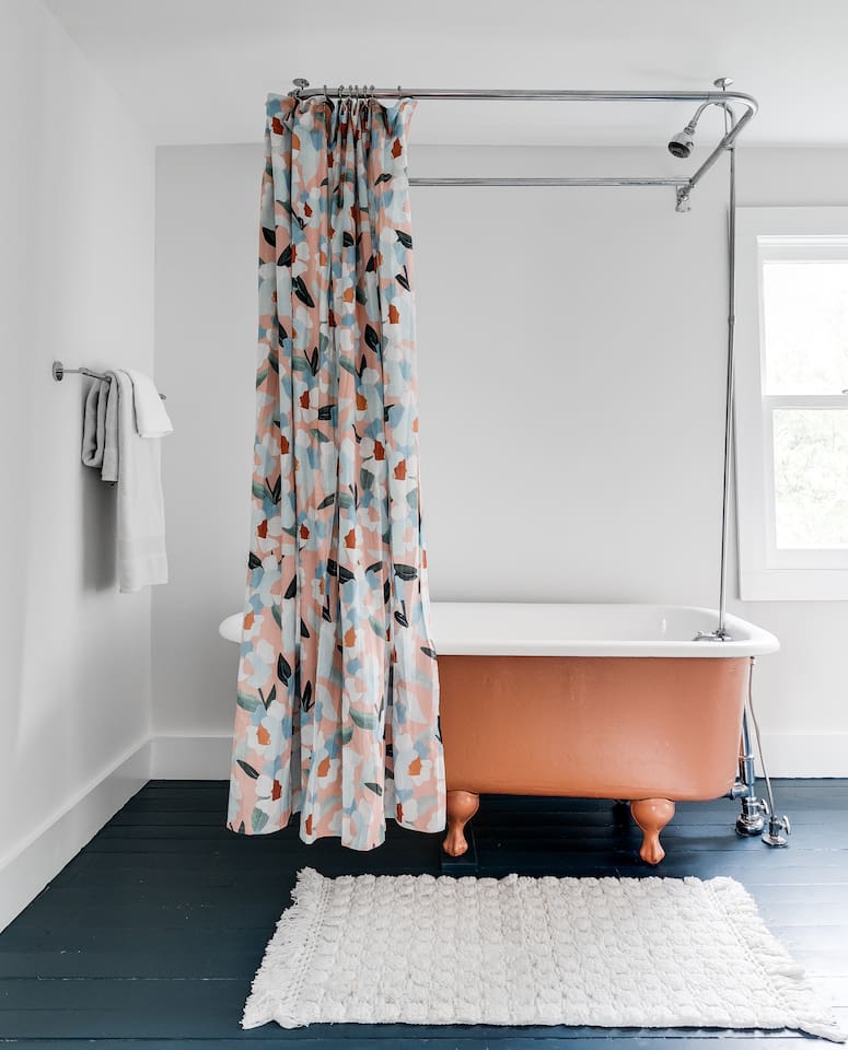 2nd Floor Full Bathroom: Delight in a vintage clawfoot tub and playful floral curtains for a refreshing retreat!