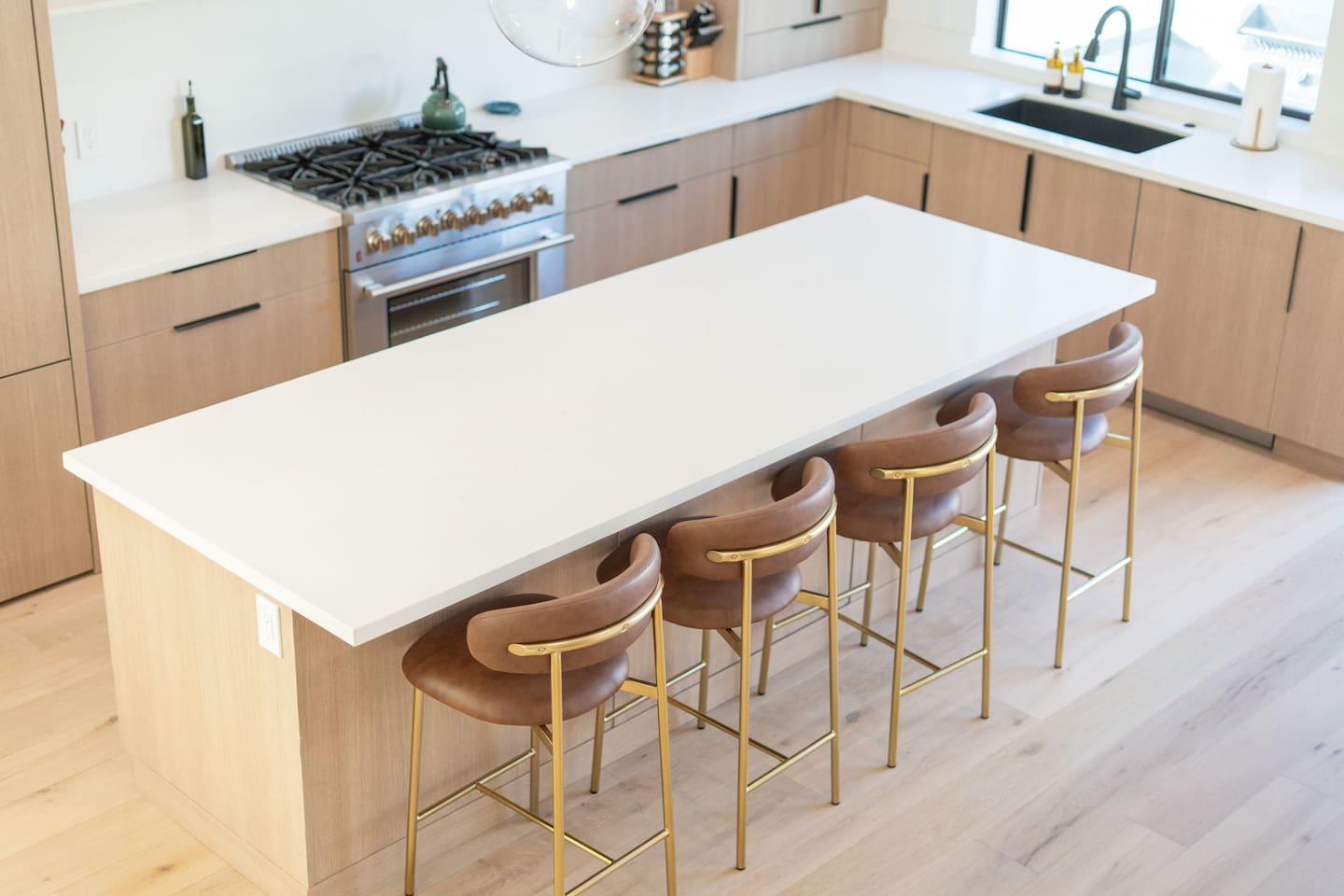 Elegant island design featuring sleek countertops and contemporary barstools.