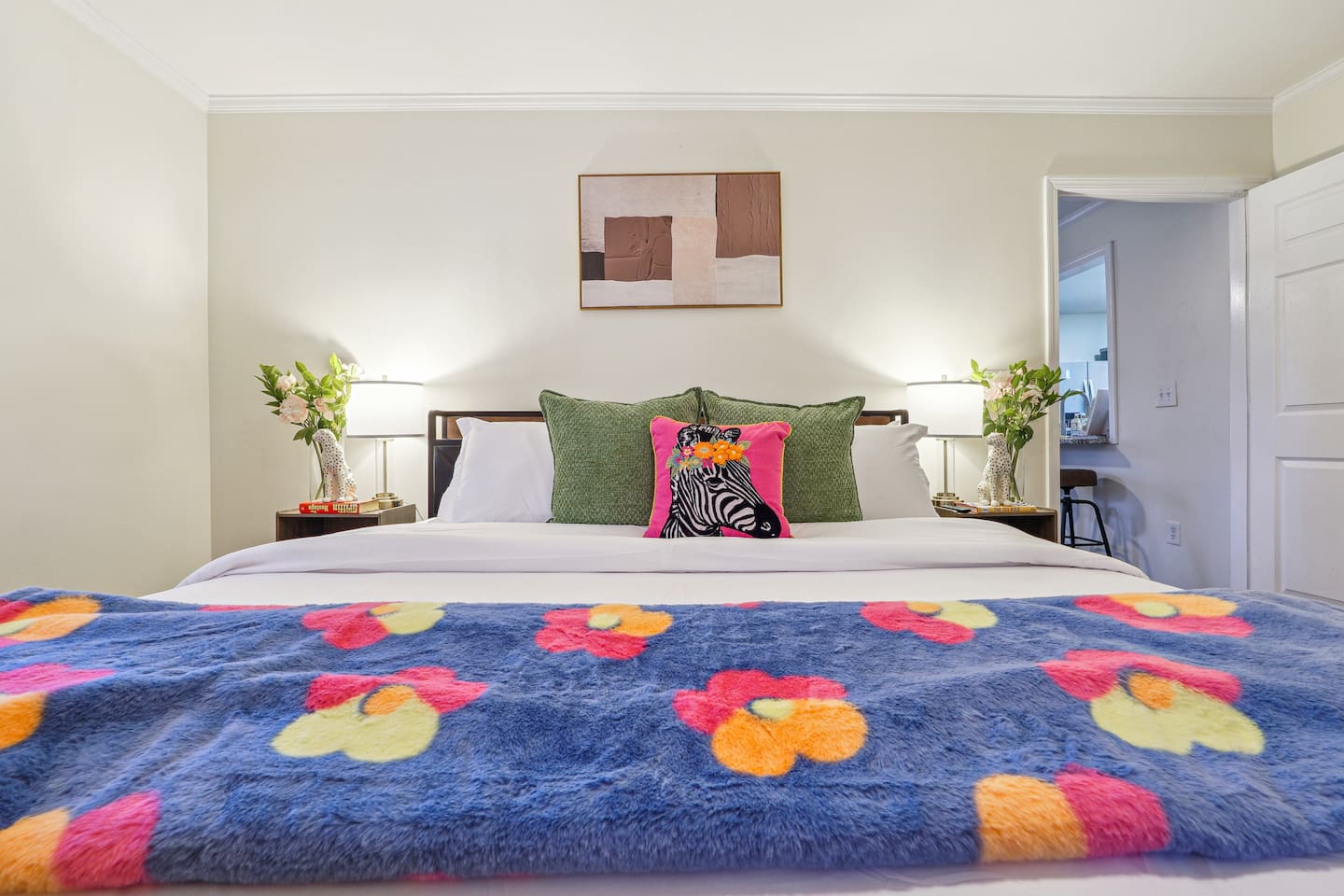A cozy bedroom featuring a double bed, a bunk bed, a window, a bedside shelf with a lamp, and a TV — perfect for families or groups to relax and unwind.
