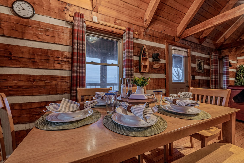Cabin-style dining setup with place settings for a shared meal