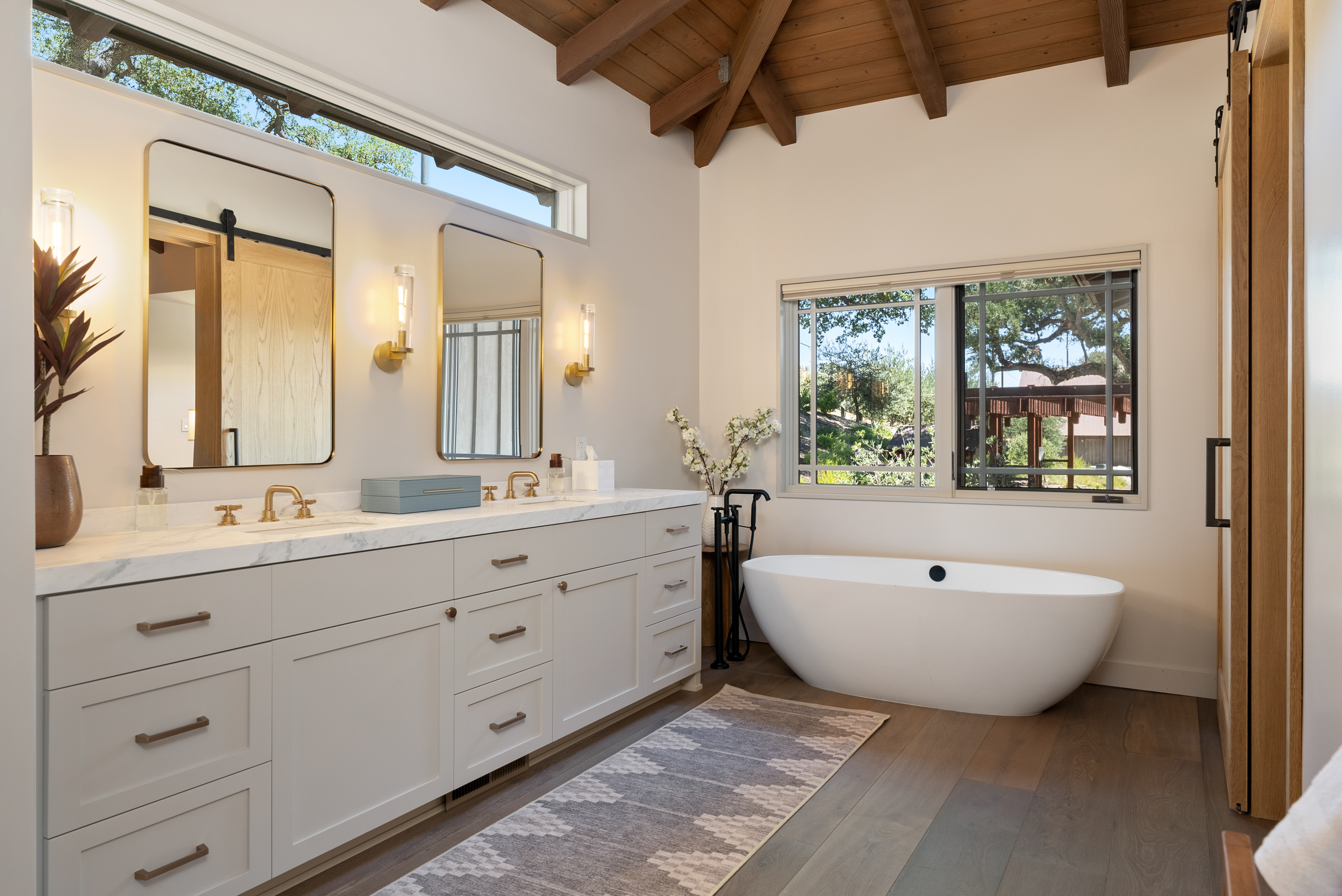 Spa-inspired bath with soaking tub, shower, and walk-in closet