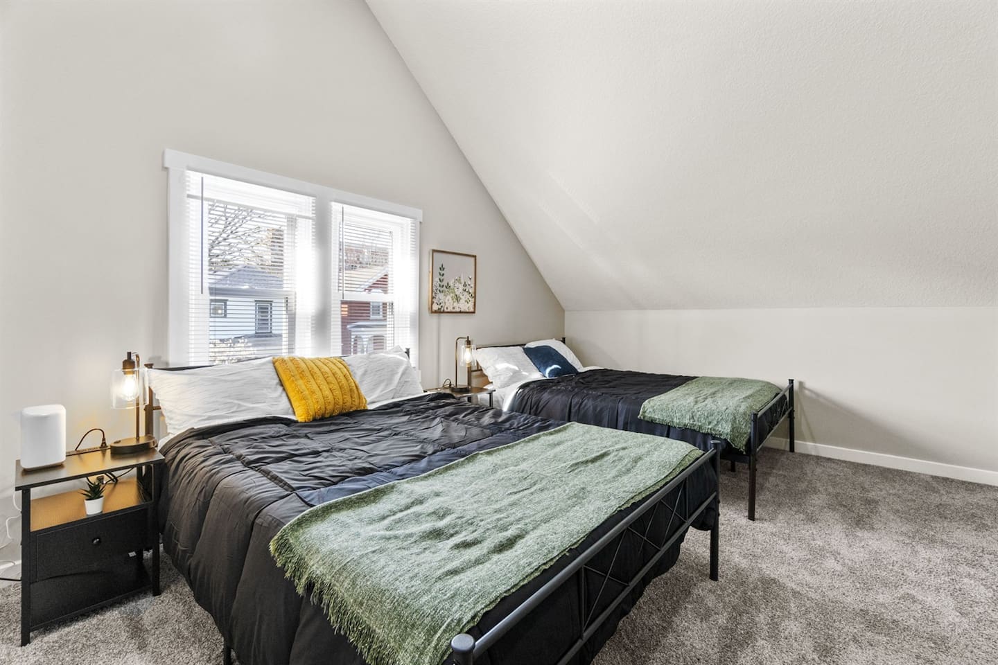 A comfortable bedroom featuring two queen beds, perfect for accommodating multiple guests.