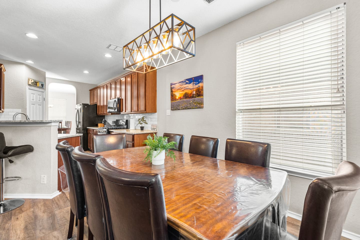 Open-concept kitchen flowing into the main dining area with seating for 8, perfect for family meals, celebrations, and effortless entertaining.