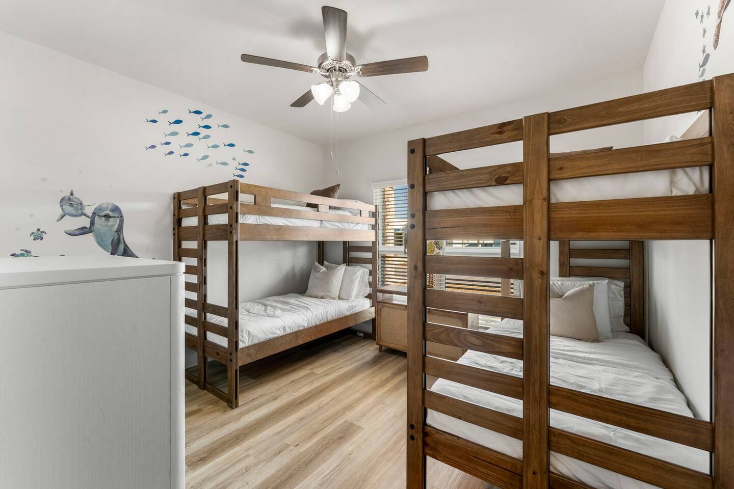 Comfortable bedroom with two bunk beds and windows for a fresh, open feel