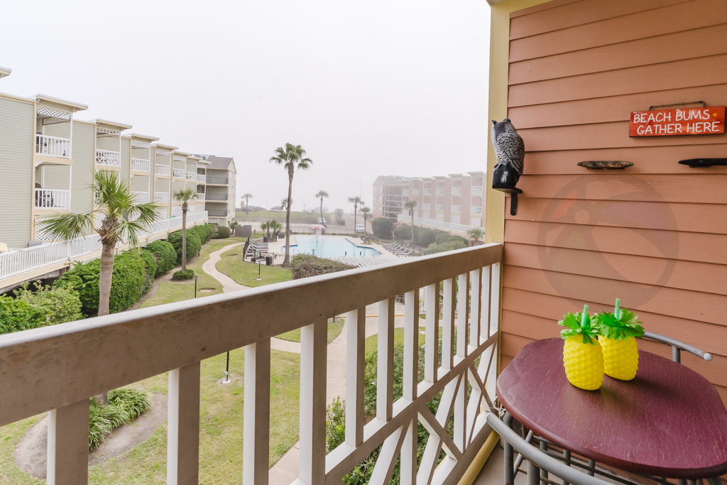 View to the pool with a small bistro table