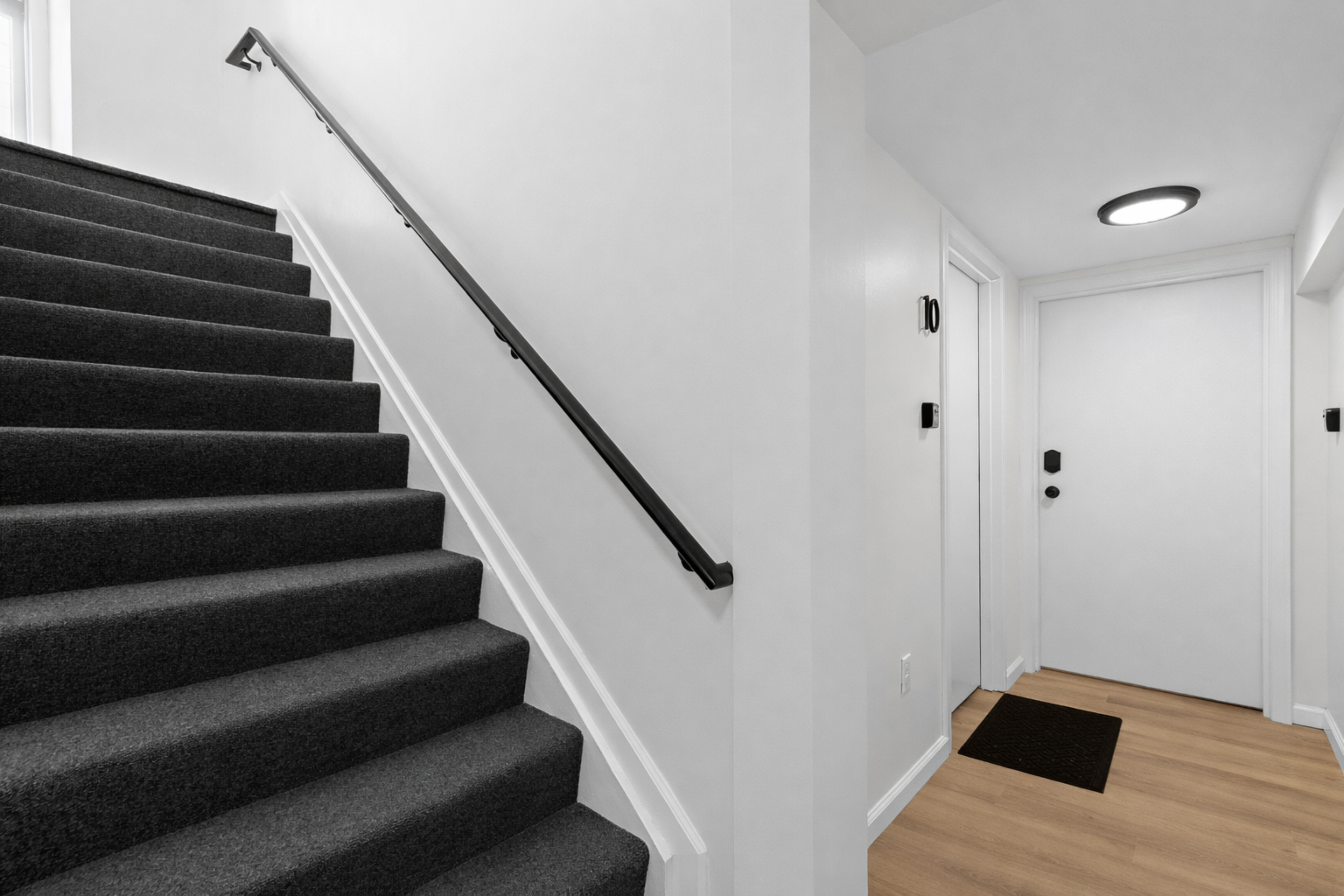 Clean, well-lit entry and stairway with modern finishes and easy access—creating a welcoming, secure arrival and smooth flow throughout the space.
