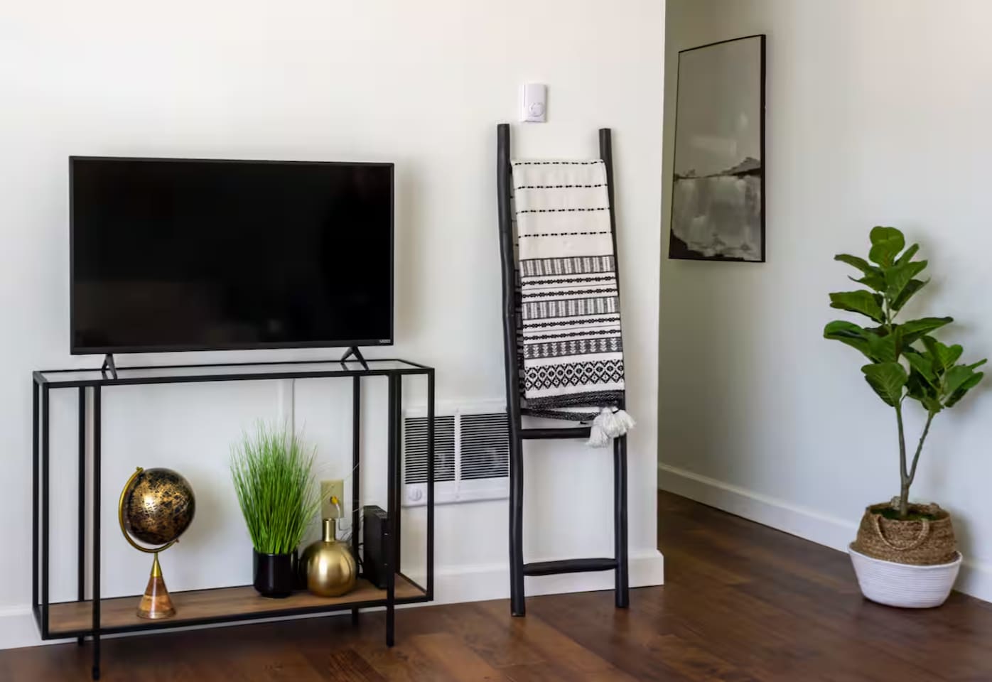 A cozy console with a globe and a soft throw ladder invite you to slow down and get comfortable.