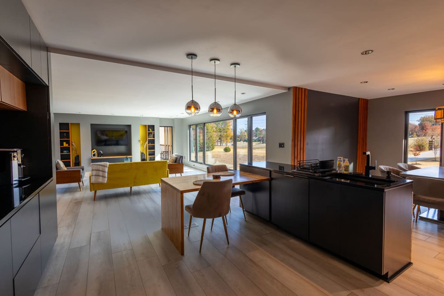 Open view from the kitchen, seamlessly connecting the dining and living areas, creating an inviting, airy space for both cooking and socializing.