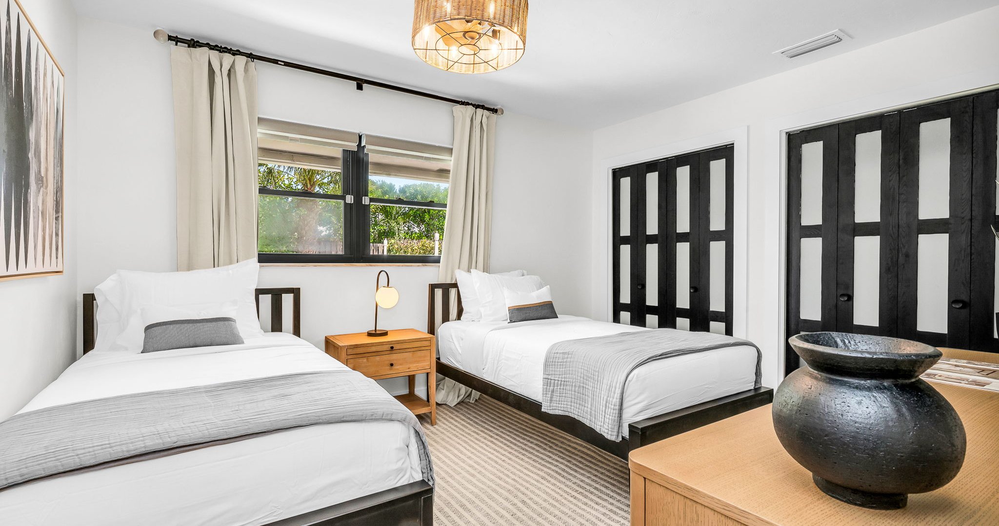 This light-filled twin bedroom combines comfort and style with coastal surf accents, two cozy twin beds, and premium linens. Guests will love the ROKU TV for entertainment and the abundant storage space, all ideally situated across from the guest bath.