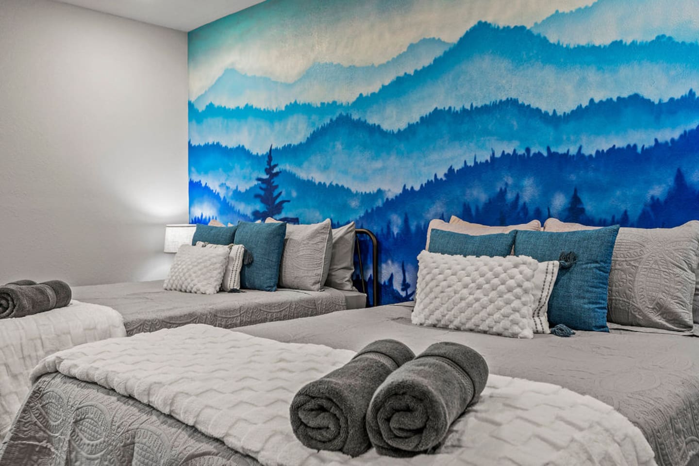 Downstairs bedroom with two queen beds and TV.