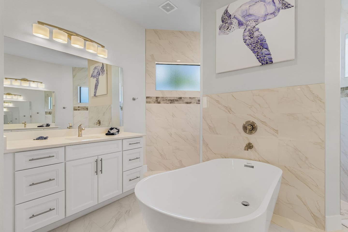 Indulge in the spacious ensuite bathroom complete with two vanities, a relaxing tub, and a separate shower for the ultimate in comfort!