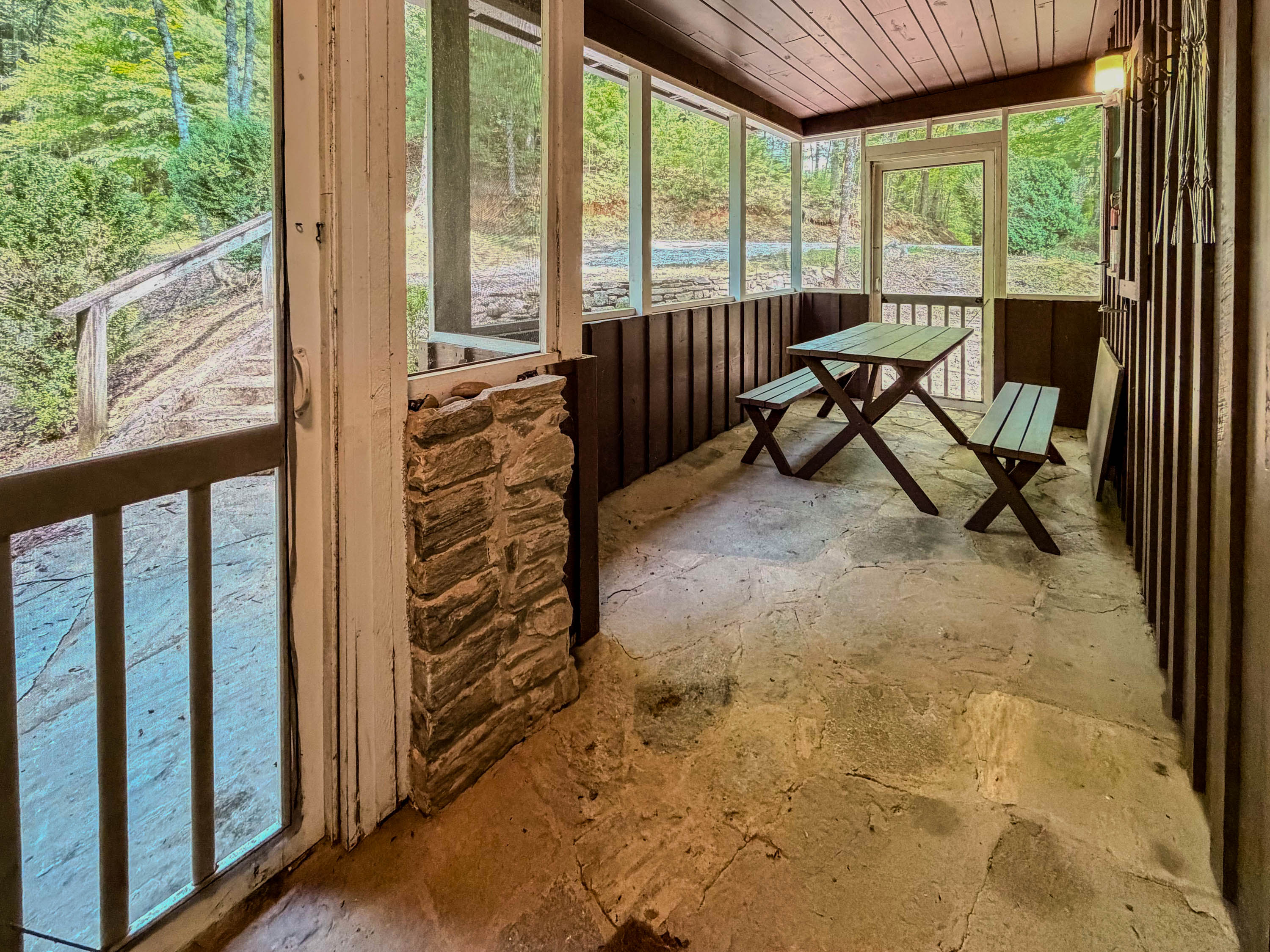 The front screened in Porch features a picnic table.