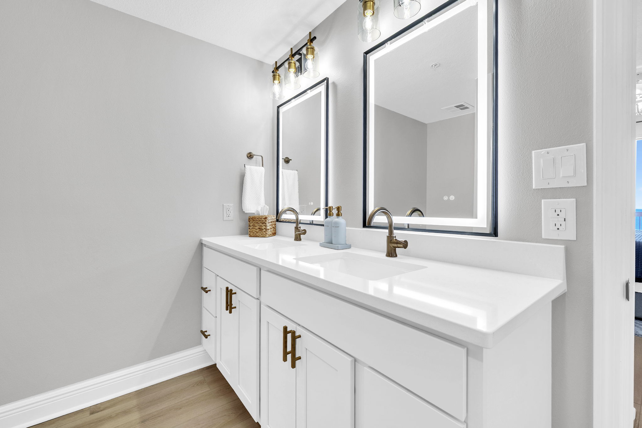 A bright double vanity featuring LED lighted, steam-free mirrors, modern finishes, and plenty of space to get ready with ease.