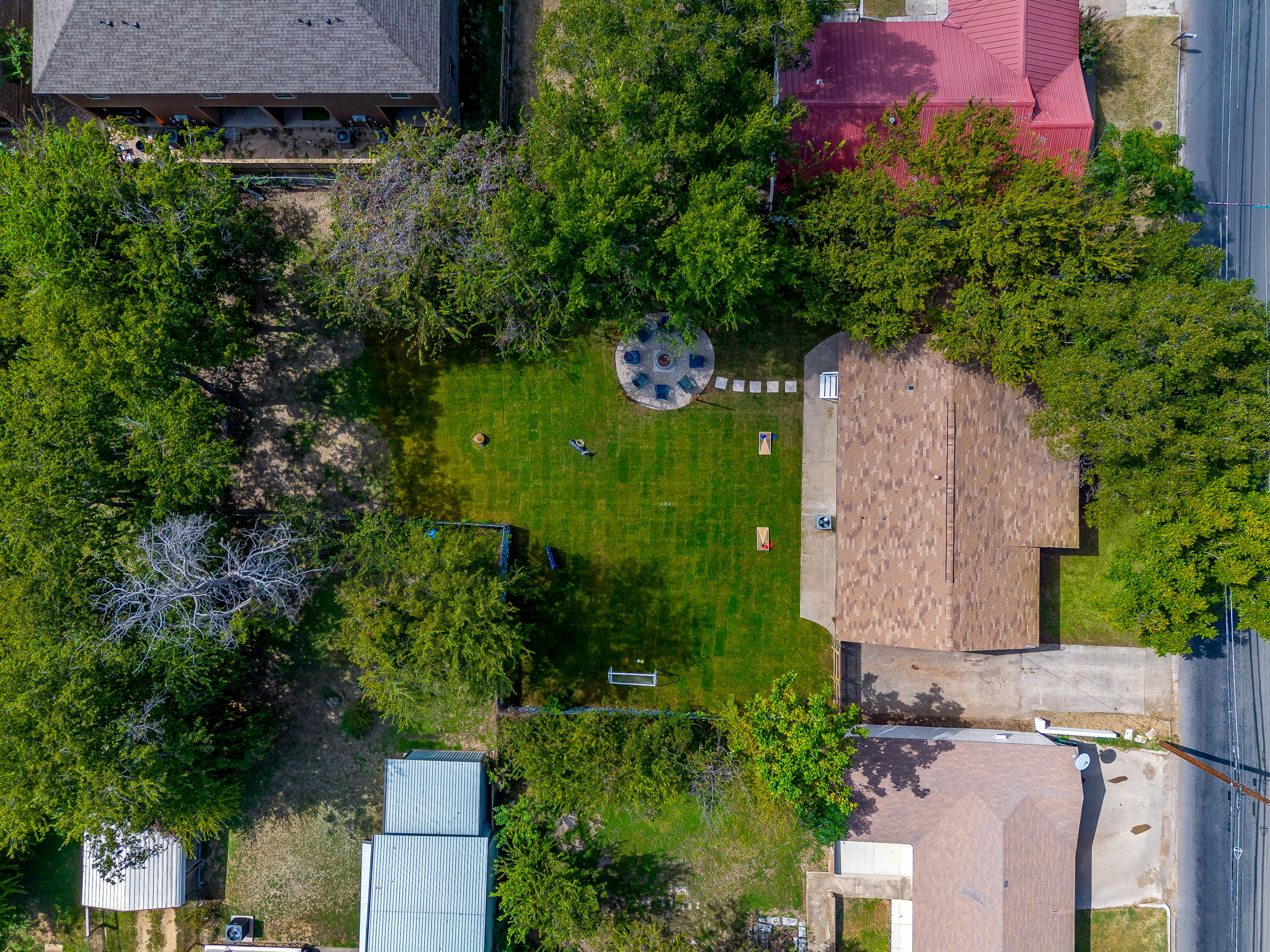 Direct overhead of the backyard shows layout of games and fire pit area