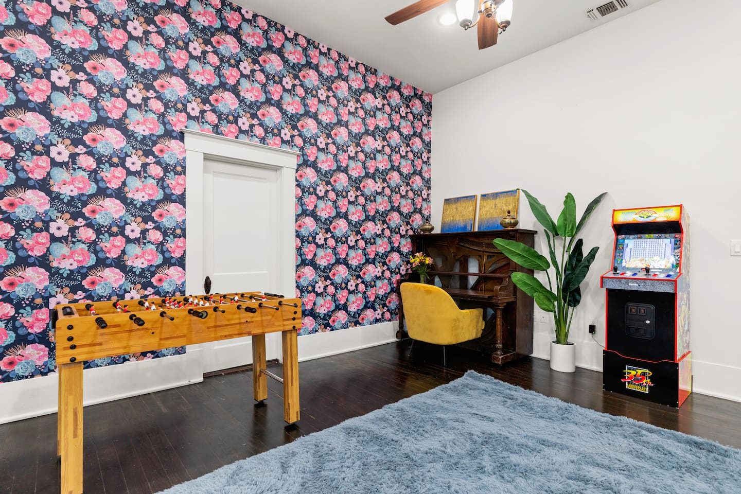 Unwind in a space where vibrant florals and classic entertainment blend seamlessly, offering both comfort and whimsy.