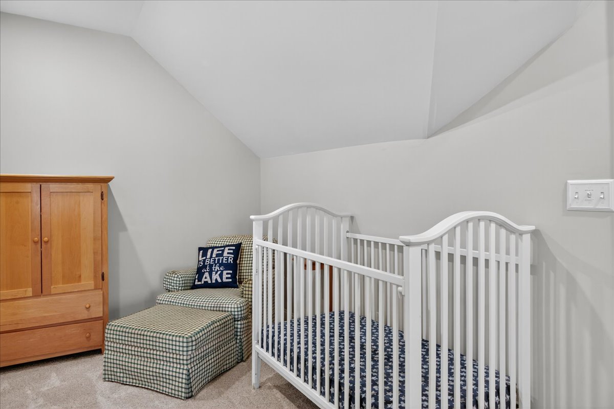 Open, but quiet space with crib and comfy lounge chair.