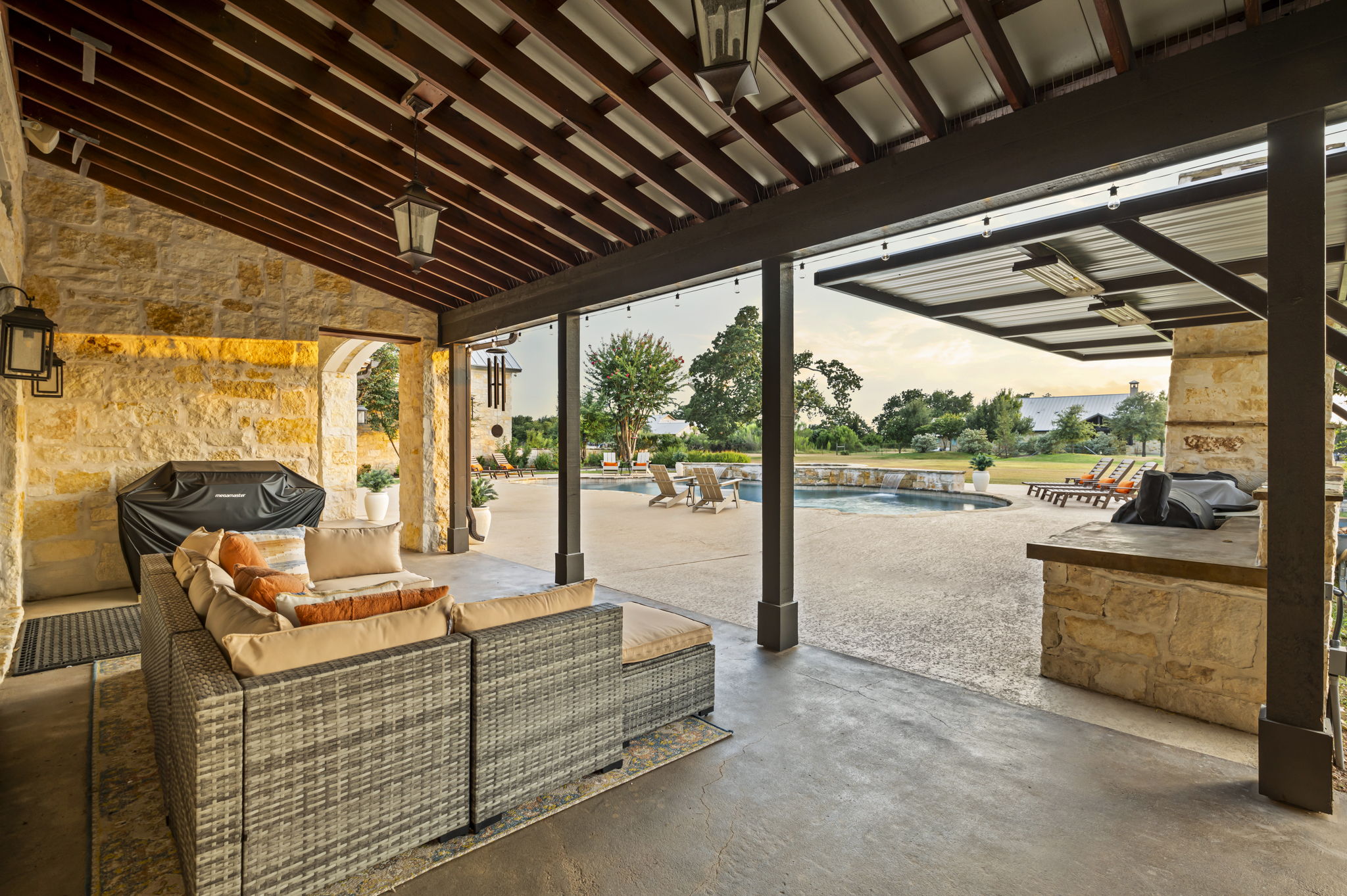 A BBQ grill on a spacious covered patio, ideal for outdoor cooking and entertaining.