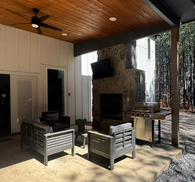 Perfect outdoor hangout with fireplace, TV, and grilling station.