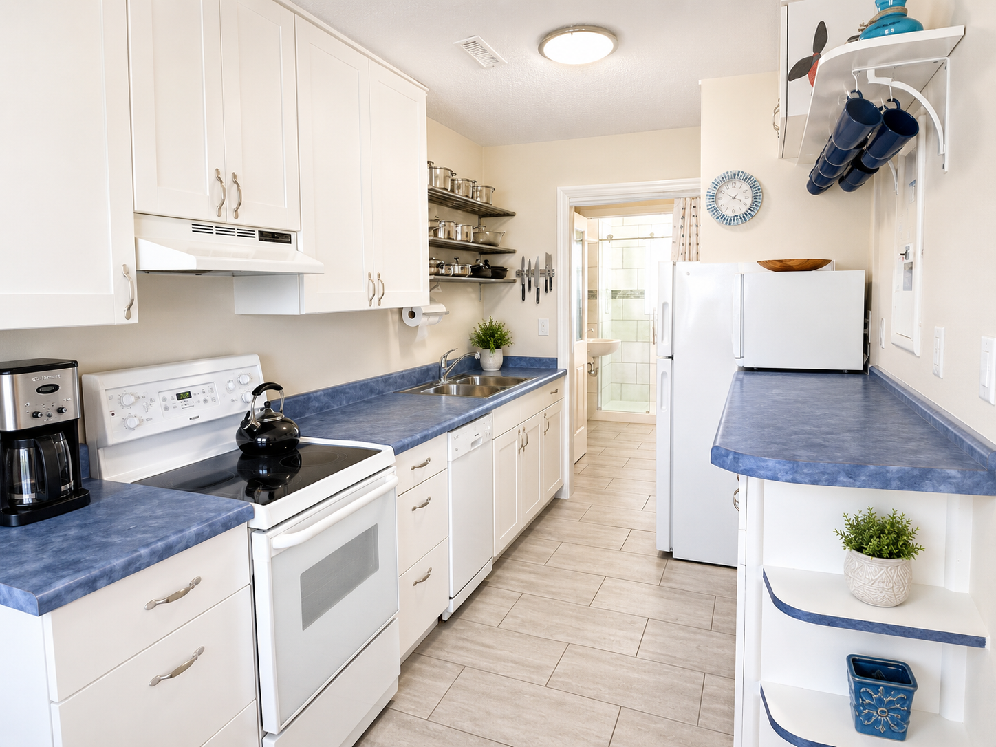 Fully stocked kitchen with all essentials plus a dishwasher. Bathroom through the doorway at the end.