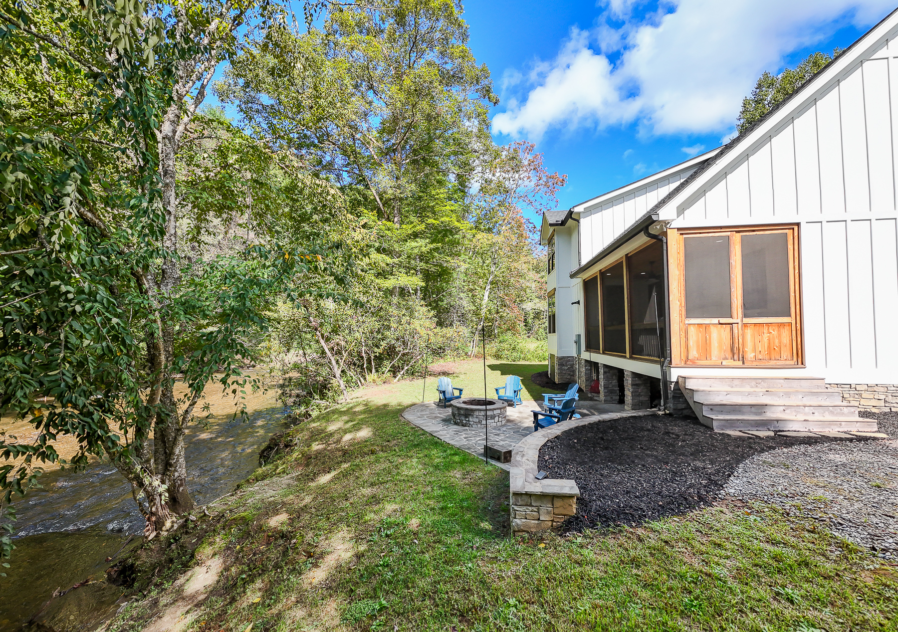 Enjoy the sounds of the creek from the screened porch or gather around the waterside fire pit at Robbin’s Nest on Snowbird Creek.