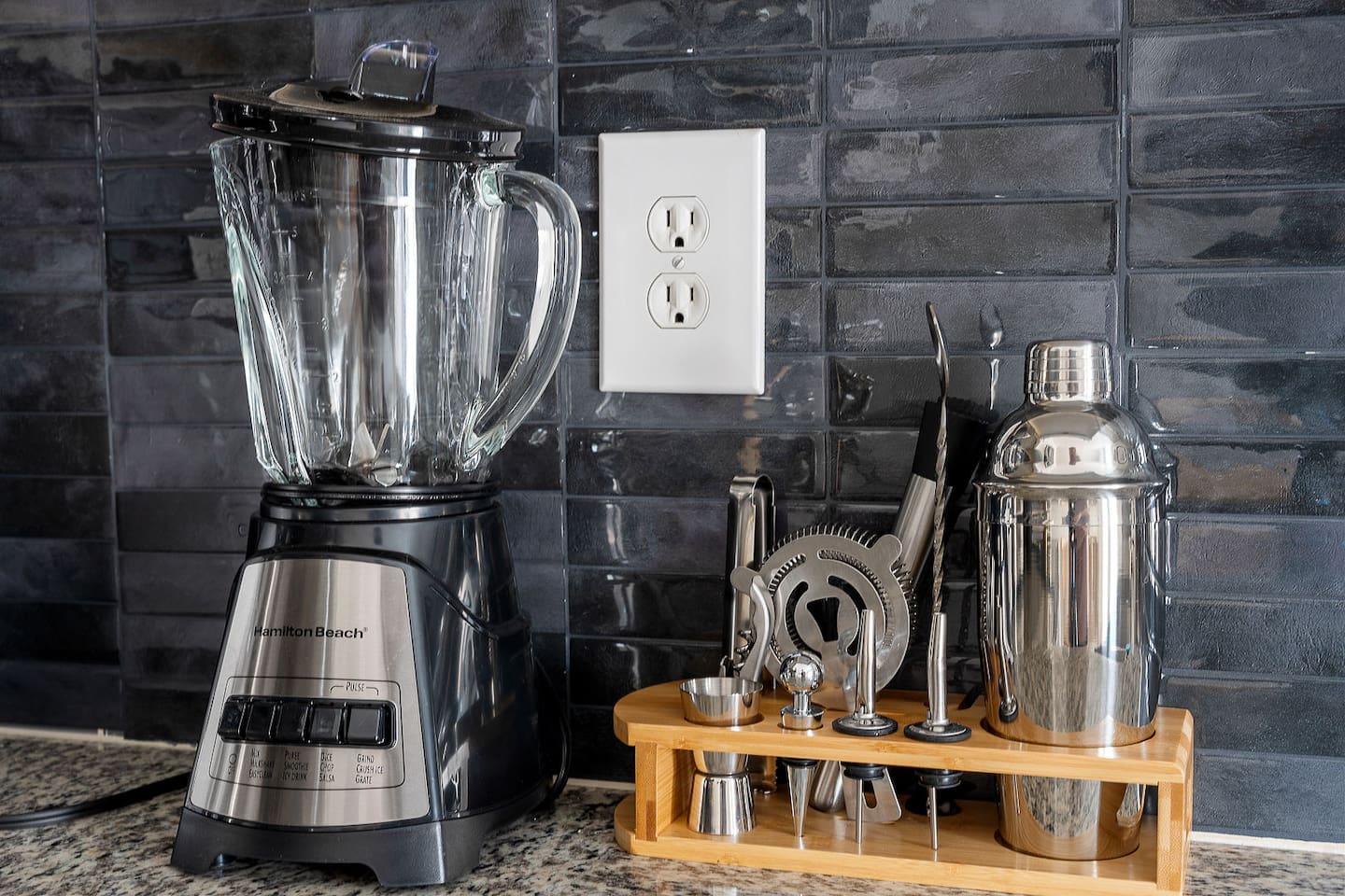 Blend and shake with ease in this well-equipped kitchen featuring a blender and cocktail shaker set. Perfect for preparing smoothies or evening drinks.