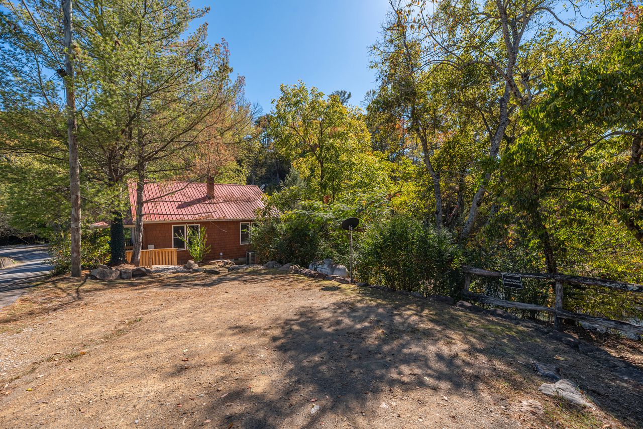 The parking area can hold three vehicles. The space is shared with the house up the street. 