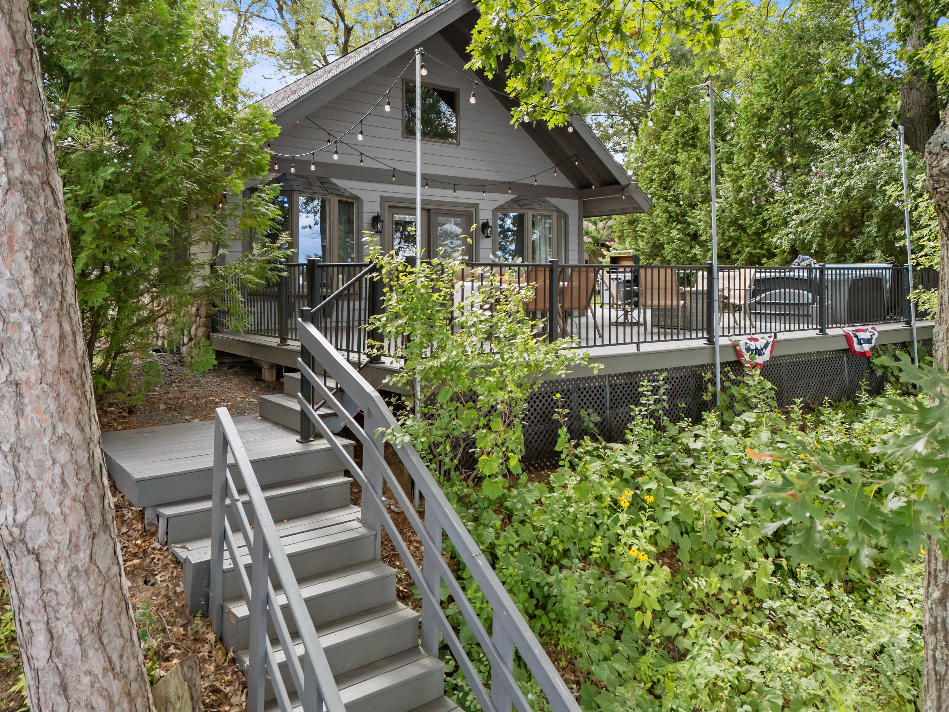 The fenced-in deck includes a gate that opens directly to the stairs for easy lake access