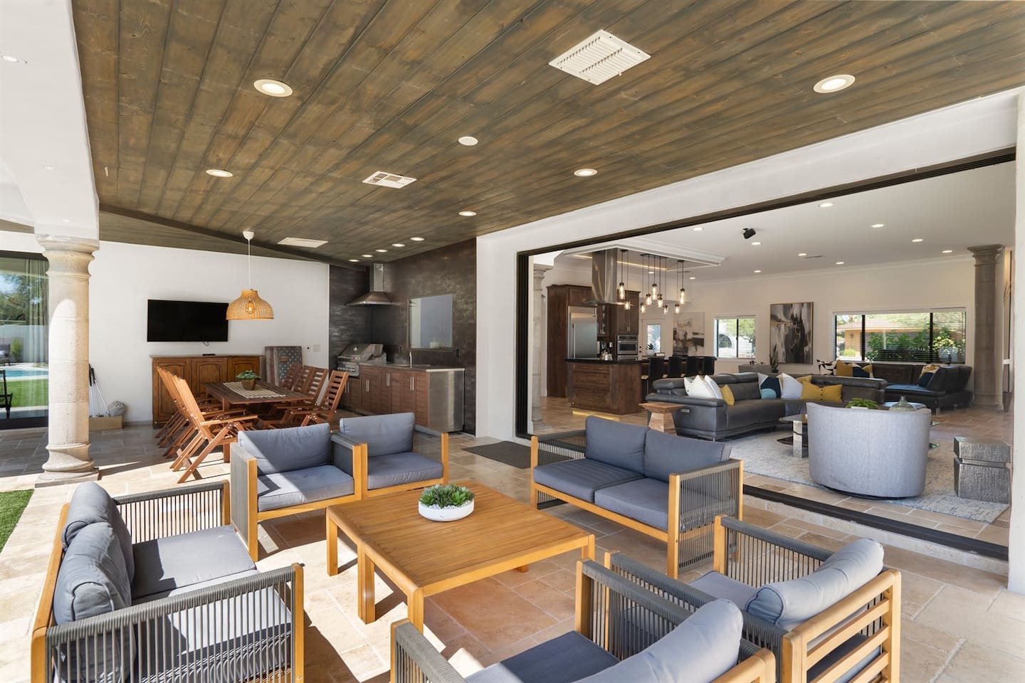 Spacious patio with cozy furniture and a dedicated dining area, perfect for grilling and outdoor meals. Enjoy al fresco dining with family and friends in this beautiful outdoor space!